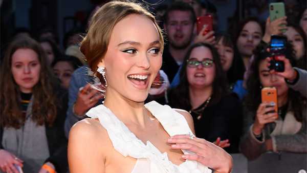 Lily-Rose Depp Acts Fast To Prevent Wardrobe Malfunction As Wind Blows Her Top At ‘The King’ Premiere