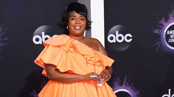 Lizzo Stuns On The AMAs Red Carpet In A Gorgeous Orange Ruffled Dress — See Pic