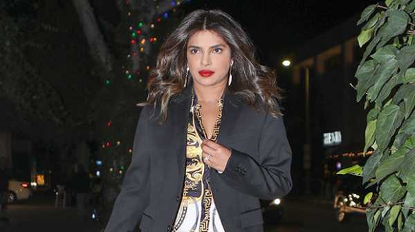 Priyanka Chopra Avoids Wardrobe Malfunction By Lifting Up Plunging Dress On Night Out