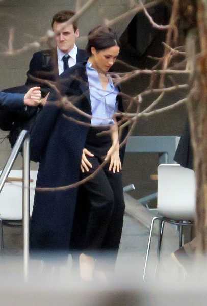 Meghan Markle Photographed in Navy Coat, Blue Blouse, and Trousers for Private Meeting in London