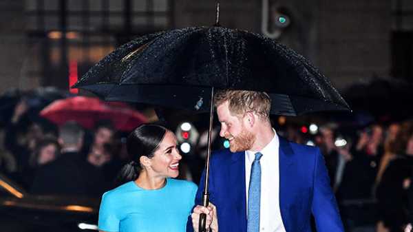 Meghan Markle & Prince Harry Cozy Up Under An Umbrella In Matching Outfits In London — See Pics