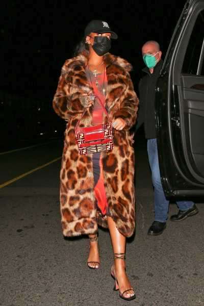 Rihanna Wore a Leopard Coat, Red Midi Dress, Fendi Bag, and Baseball Cap to Dinner