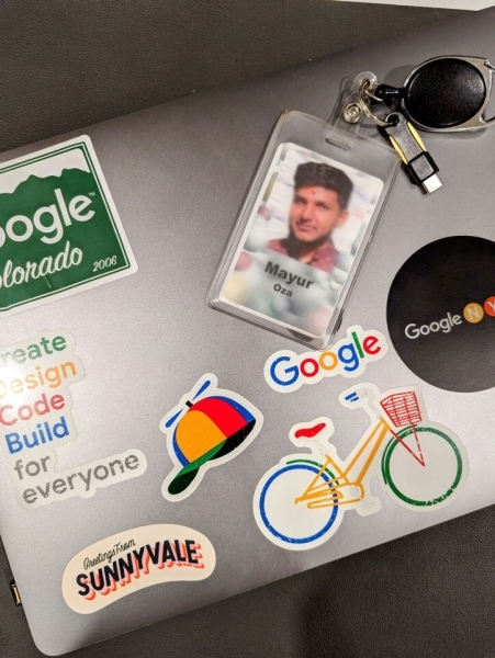 A picture of Mayur Oza's laptop and badge.