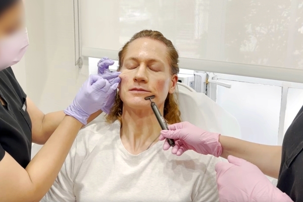 Bryan Johnson sits in a chair while undergoing a skin treatment.