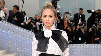 Emily Blunt Rocks A Largerfeld-Inspired Lace Top With A Massive Bow & Sequin Pants To Met Gala