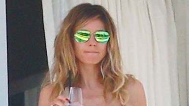 Heidi Klum, 50, Rocks Cutout Floral Swimsuit While Serving Plates Of Food On Vacay: Photos