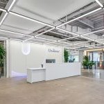 The reception desk in the new Hoboken Unilever office. Bright white desk with blue Unilever accents. (Photo: Unilever)