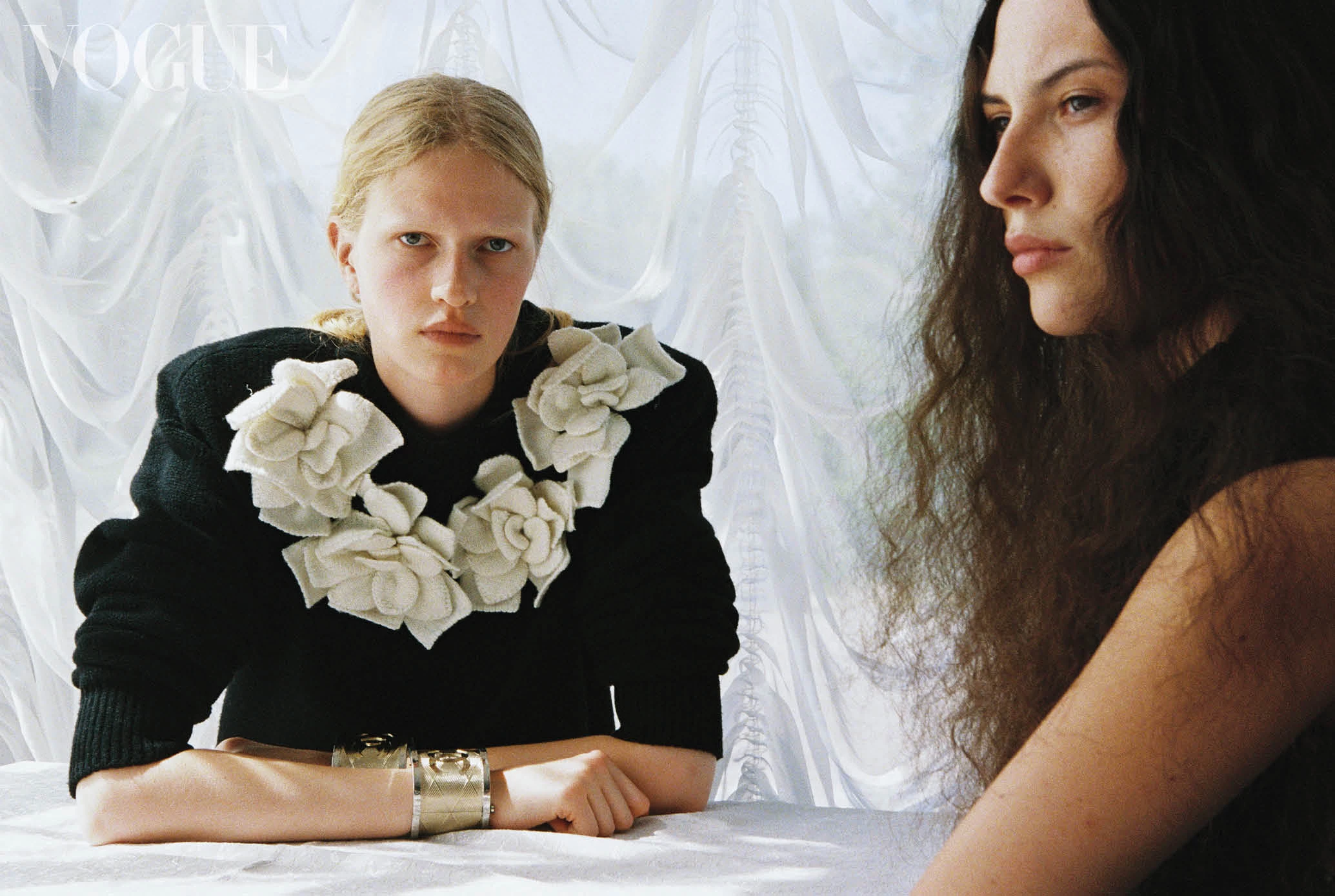 On Marina: wool sweater, two bracelets, brass, all by Chanel. On Stefania: viscose and polyester dress, Poustovit.15