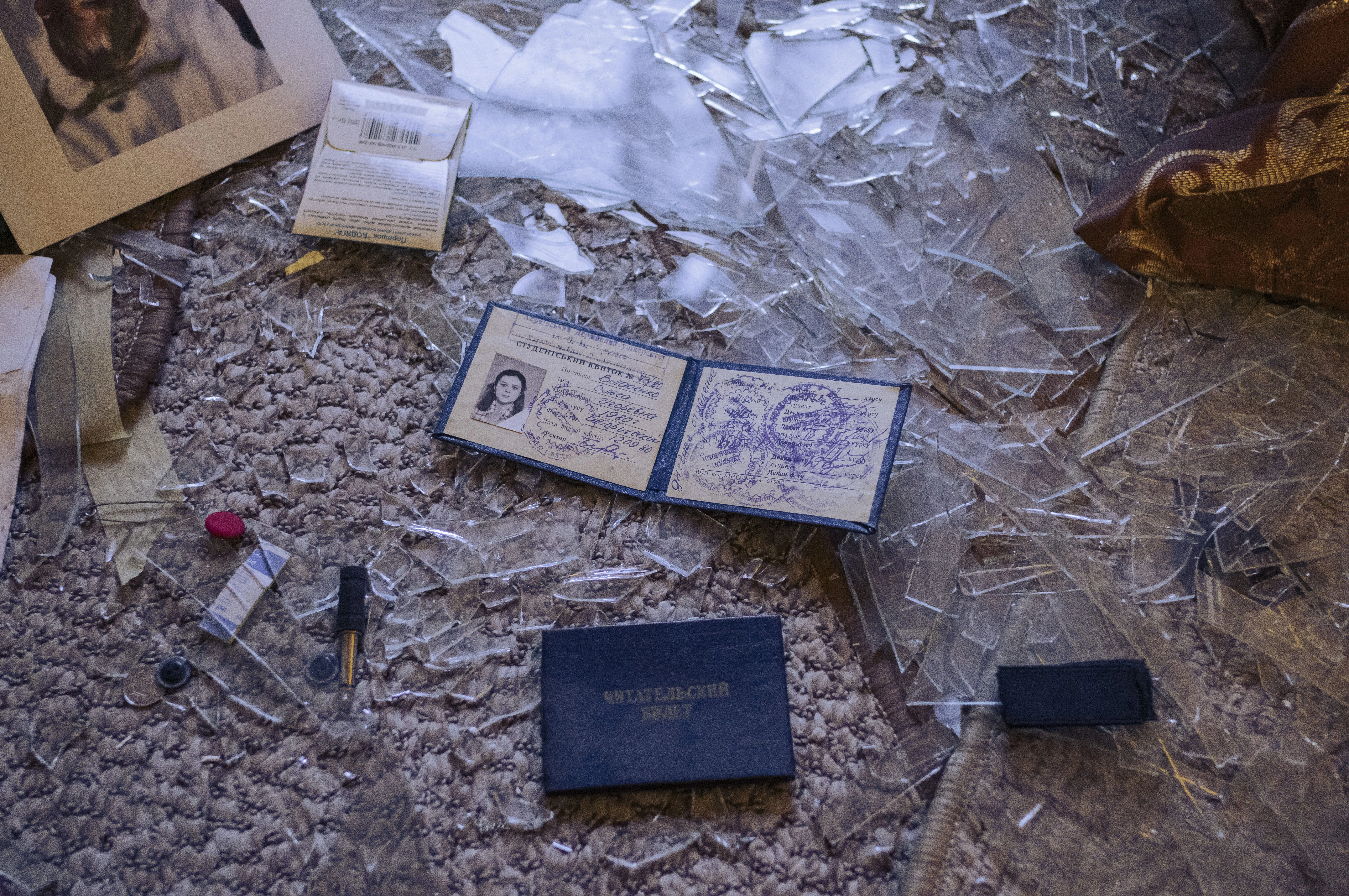 The photographer's mother's student ID card, lying in the rubble in her damaged apartment after Russian shelling, July 2025. Photo: Sasha Maslov14