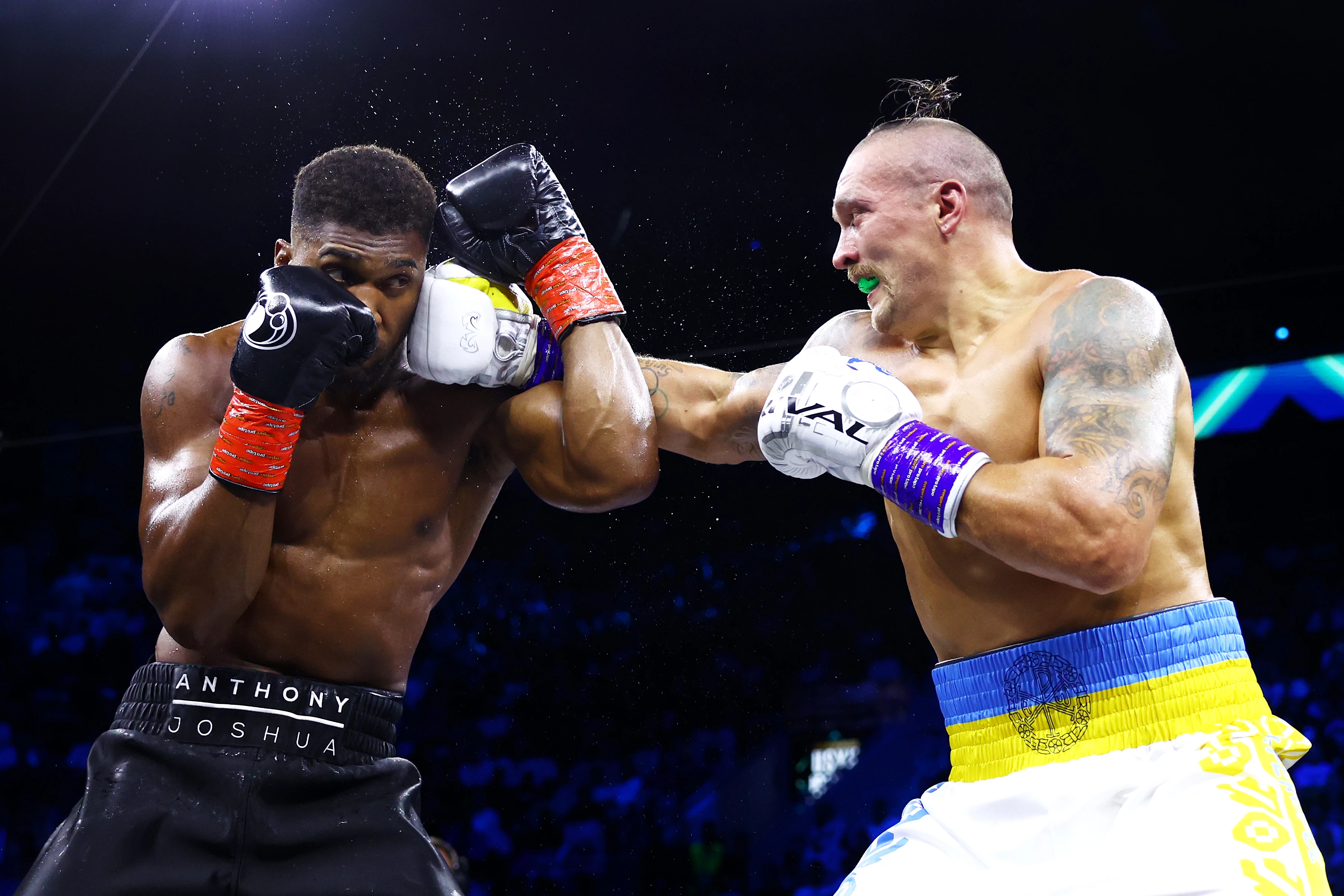 Oleksandr Usyk lands a punch against Anthony Joshua during their world heavyweight title fight at the King Abdullah Sports City Arena. Jeddah, Saudi Arabia, August 20, 202215