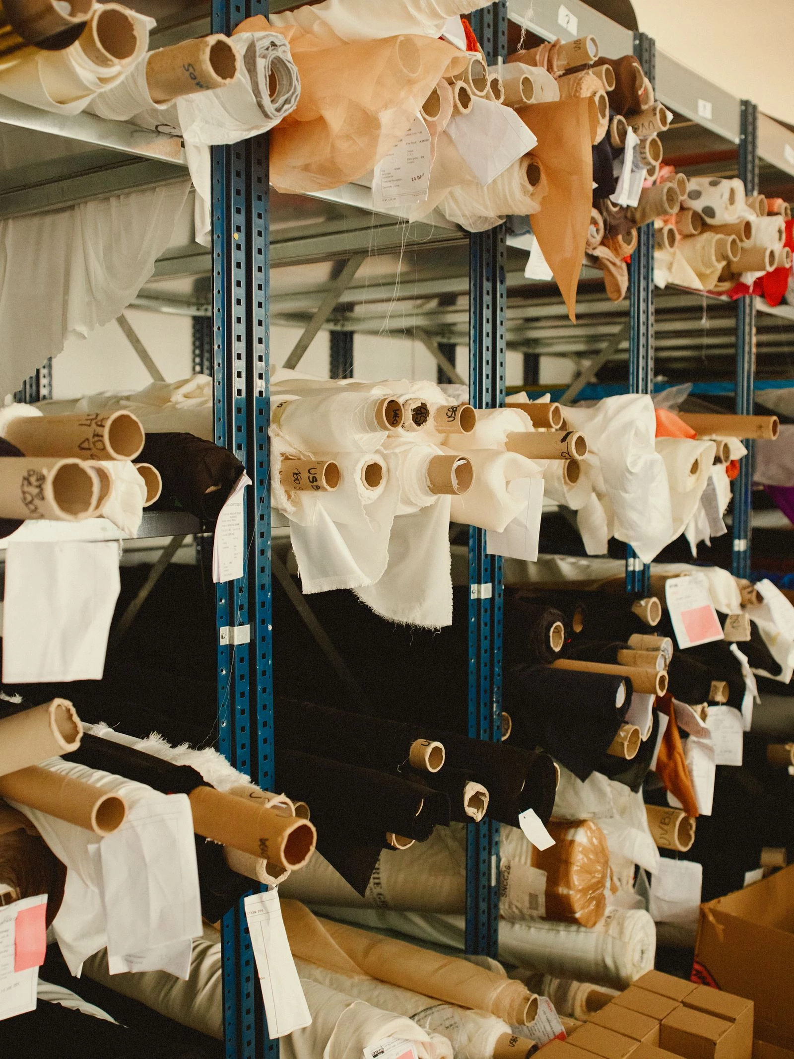 Rolls of fabric in a Balmain warehouse. Photo: Lee Whittaker3