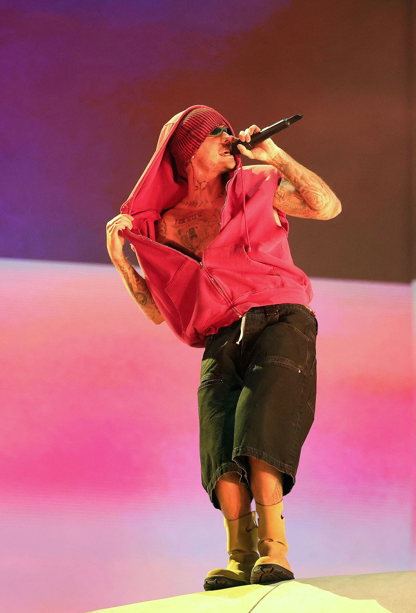 During the second weekend of Coachella, Justin Bieber wore Skylrk denim shorts, a Greg Ross hoodie from Los Angeles, and Loewe boots.4